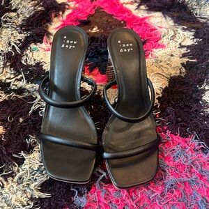 Black sandals with snakeskin heel